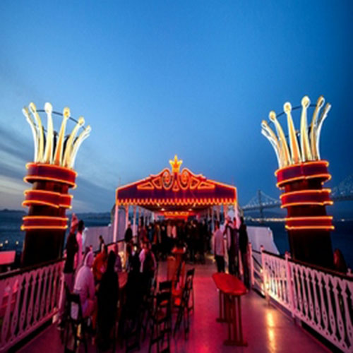 Amusement park carnival entrance at night lit up