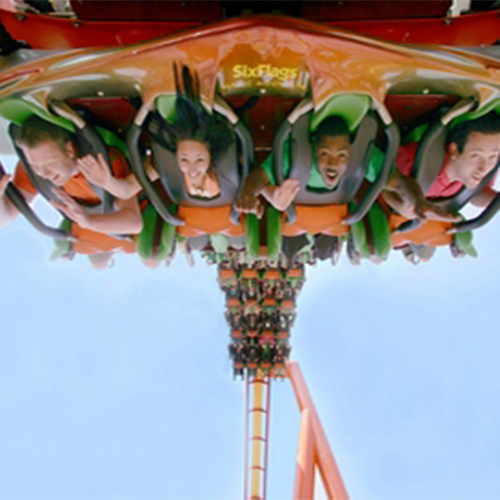 People on the Tatsu ride at Six Flags Magic Mountain hanging upside down