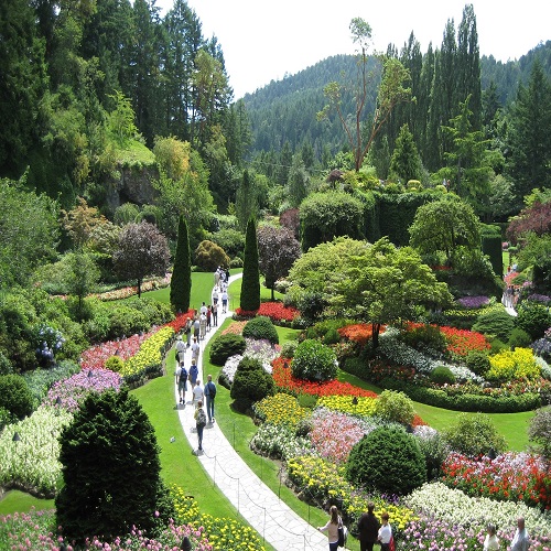 People walking along a paved trail in Butchart Gardens in Canada