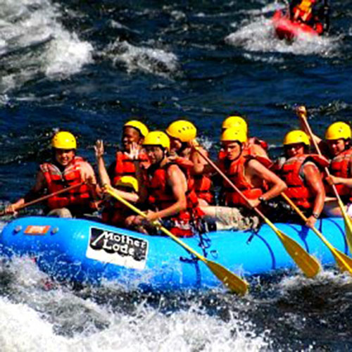 Group of students white water rafting on the American River during a school trip